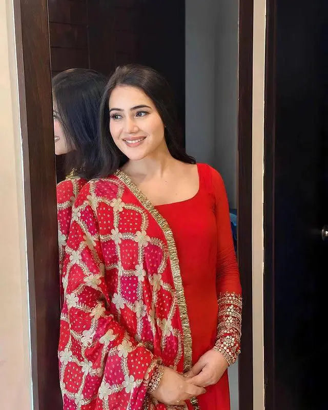 Elegant Red Embroidered Suit with Intricate Floral Patterns and Patola Dupatta